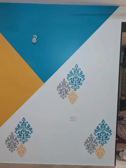 This accent wall mixes modern color blocking with classic stencil art, demonstrating our ability to blend different decorative painting styles.