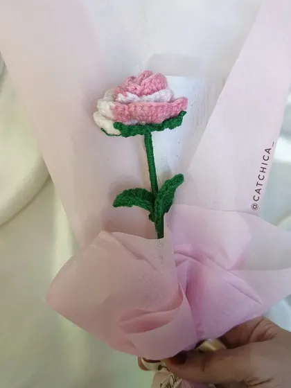A close-up of our two-toned pink and white crochet rose, beautifully wrapped in pink paper.
