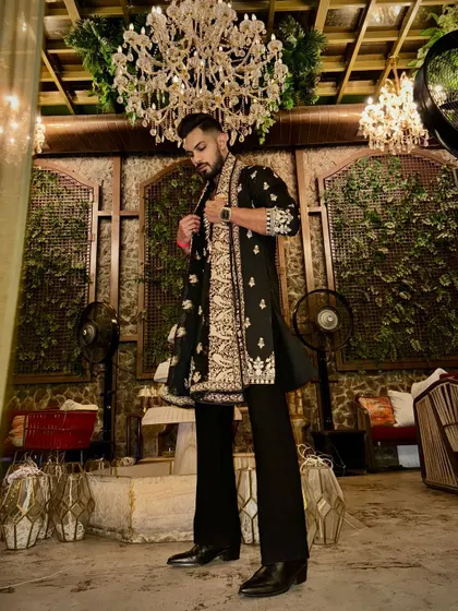 Adjusting the shawl, this candid shot shows the outfit in motion. The heavy embroidery on the shawl drapes beautifully over the kurta, adding a touch of regal flair.
