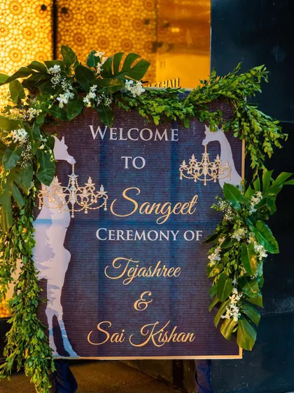 The welcome signage for a tropical-themed Sangeet. The design incorporates giraffe silhouettes and chandeliers, giving guests a hint of the unique and playful decor inside.