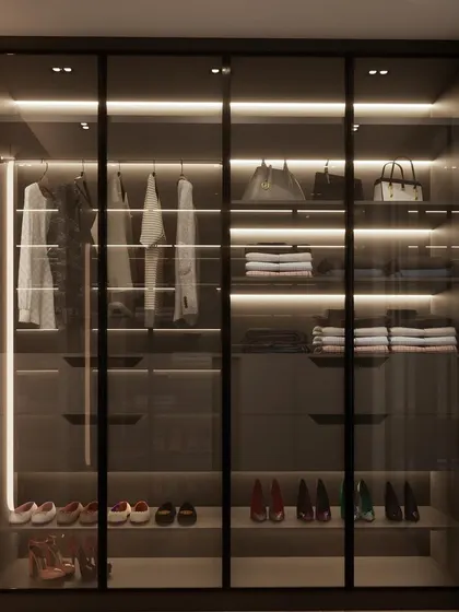Couple closet goals! This is the 'Hers' side of a walk-in closet I designed for a client in a small space. The glass doors and integrated lighting create a boutique-like feel.