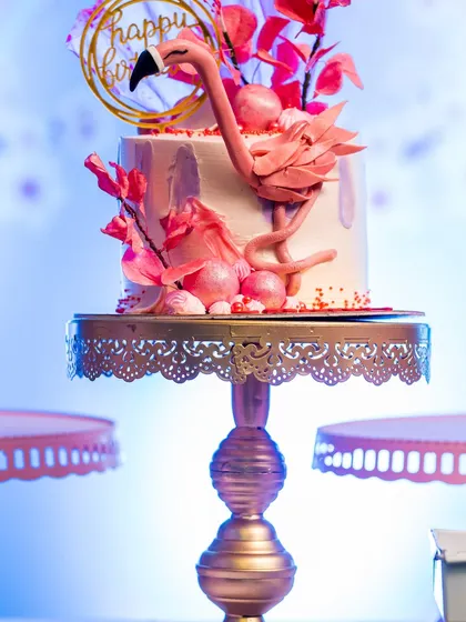 A stunning flamingo-themed cake, adorned with delicate, edible feathers and flowers. This cake is a work of art and the centerpiece of the dessert table.