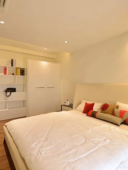 In this 4000 sq. ft. showflat, the all-white palette is a spatial strategy. By keeping the guest bedroom minimal and pristine, the room feels significantly larger, brighter, and more inviting, showcasing a timeless and elegant aesthetic.