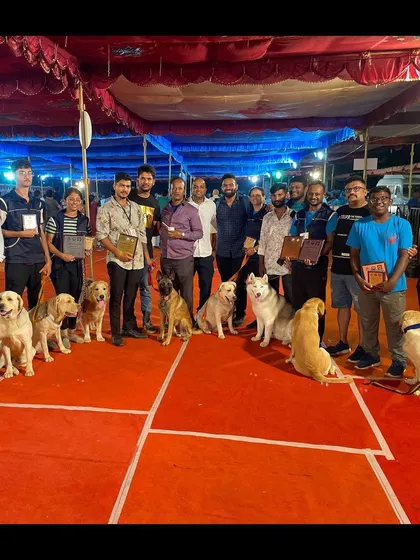 The winning lineup from the Karavali Dog Show in Mangalore. Our team proudly displays their awards with their well-trained Labradors, Belgian Malinois, and Husky.