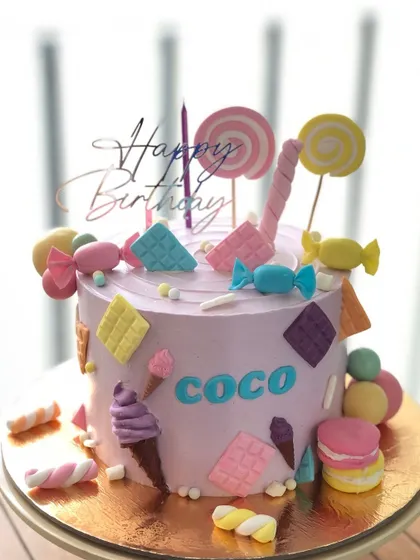 Another view of the pastel Candyland cake, showing all the different types of edible candy decorations.