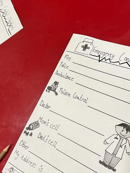 An important life skill lesson during winter camp: learning about emergency contact numbers.