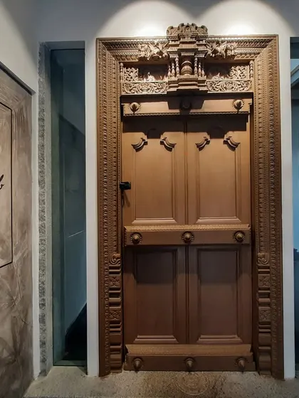The entrance to our "Dream Lab" features an antique, intricately carved wooden door. This piece of traditional craftsmanship stands in contrast to the modern office, symbolizing our philosophy of rooting innovation in heritage.