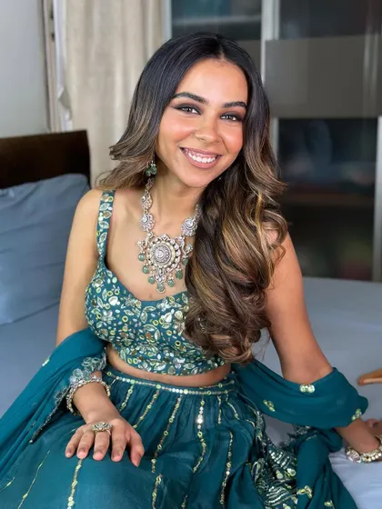A happy and glowing bride. The soft smokey eye and voluminous hair create a look that is both glamorous and approachable.