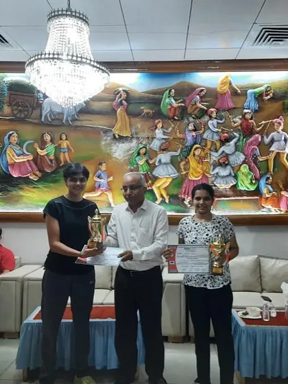 Tanisha and her partner receiving their trophies at the Gujarat State Ranking Tournament.