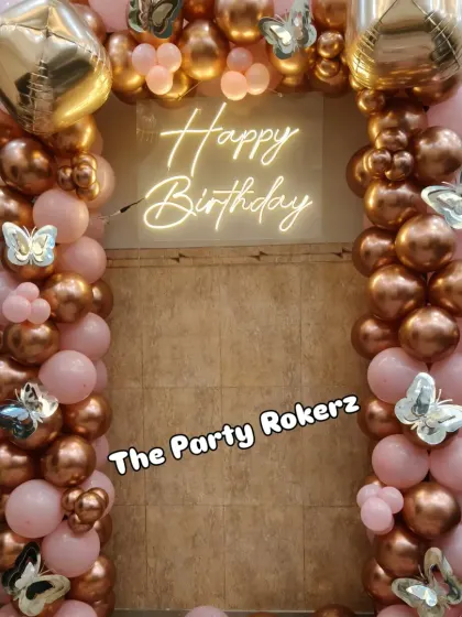 Another view of the rose gold and pink balloon arch, a popular choice for creating a stylish and celebratory photo corner in any space.