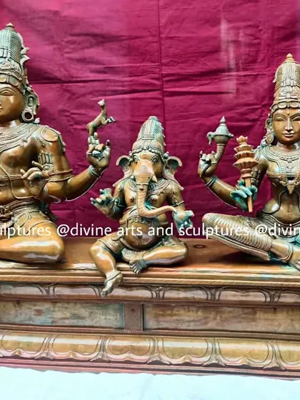 This is a complete Shiva Parivaram, or Shiva's family, featuring Lord Shiva, Goddess Parvati, and Lord Ganesha. The 24-inch Panchaloha sculpture is finished with an antique green oxide patina, giving it the timeless appearance of a treasured temple heirloom.