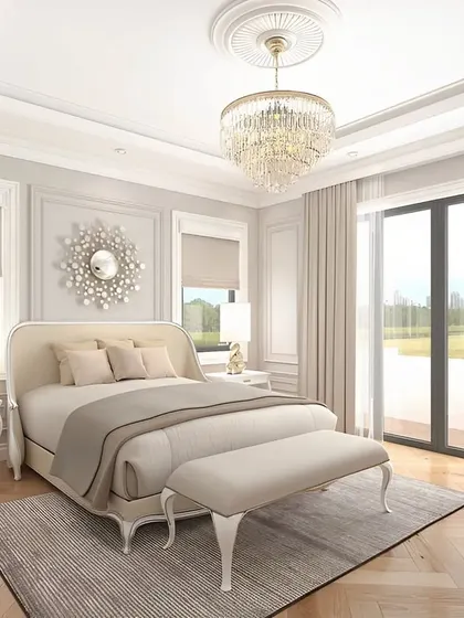This bright, neoclassical bedroom features elegant wall mouldings, a crystal chandelier, and classic furniture. It's a timeless design that exudes grace and sophistication.