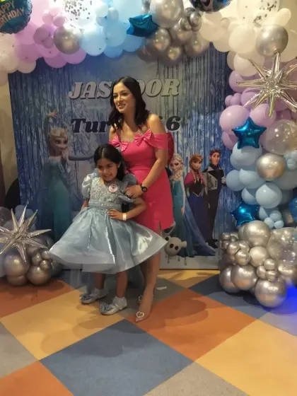 The birthday girl poses with her mom in front of our stunning Frozen-themed backdrop. We ensure our decorations create the perfect photo opportunities for you to capture these precious memories.
