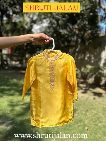 This sunshine-yellow kurta features a beautifully embroidered neckline. It’s a simple yet elegant detail that elevates the entire outfit, making it perfect for festive occasions.