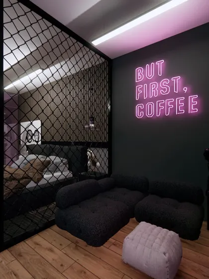 The gaming room is separated from the bedroom by a chain-link partition, adding an industrial feel while keeping the space open.