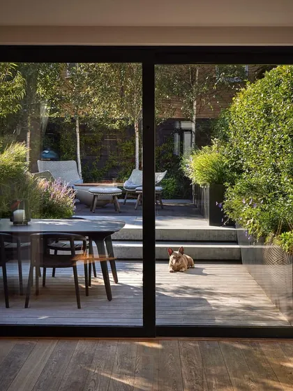 This project shows how we can create a seamless transition from indoors to a stylish outdoor deck. The elevated wooden deck provides a perfect space for dining and relaxing, extending the home's living area into the garden.