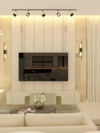 This bright and airy living room uses a white-on-white color scheme with fluted wall panels and track lighting to create a clean, minimalist aesthetic. The design focuses on texture and light to add depth and character to the space.