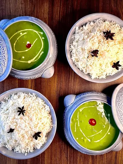 A top-down view of our Thai Green Curry and Jasmine Rice, served in beautiful ceramic bowls. This dish is a perfect example of our authentic Pan-Asian offerings.