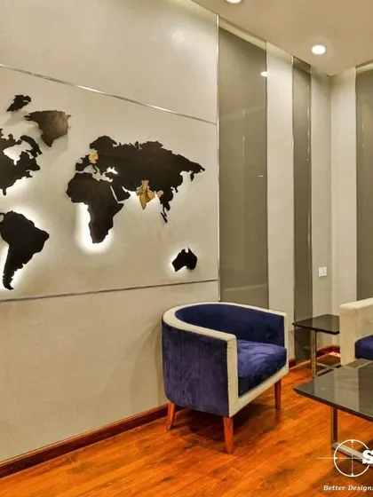 A waiting area featuring a custom backlit world map, creating a strong visual statement. The combination of plush velvet chairs and rich wood flooring provides a comfortable and impressive space for visitors.