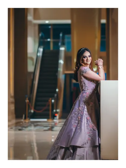 The bride looking elegant and poised in her reception gown. The modern setting with an escalator in the background adds a contemporary feel to this bridal portrait.