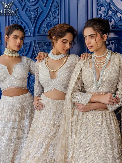 Golden opulence, redefined. These ensembles from RUVAAH are adorned with intricate zari work and shimmering sequins, perfect for bridesmaids or modern brides.