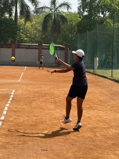 A young female player executing a clean forehand volley. We teach our players to be comfortable and aggressive at the net.