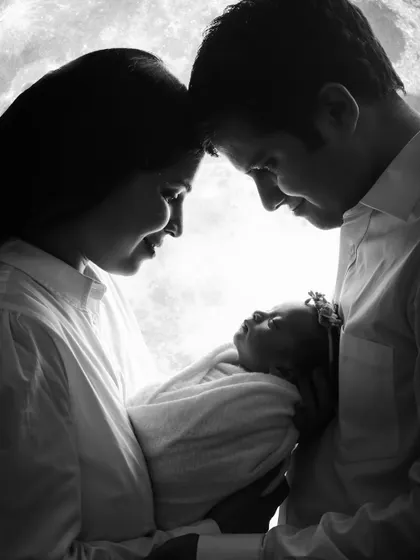A powerful and artistic silhouette capturing the profound love and connection as new parents hold their baby. These are the quiet, intimate family moments we live to preserve.