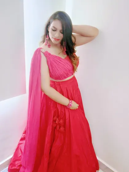 My client posing in her custom red draped gown. The pleated bodice and tassel details add texture and movement to this beautiful piece.