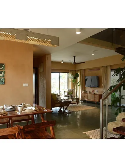 The open-plan living and dining area in a Terravana villa. The space is visually connected, promoting a sense of flow and spaciousness, with natural light from multiple sides.