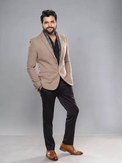 This full-length shot showcases the complete red carpet styling for Kshitish Date, from the tailored blazer to the polished leather shoes.