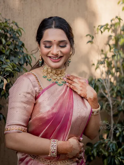 A serene, eyes closed moment. You can see the soft shimmer on her lids and the flawless, dewy skin.
