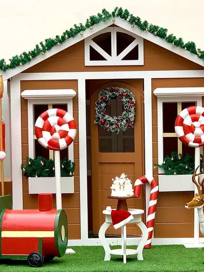 A wider view of the gingerbread house setup, which can be combined with our red train prop and other festive elements for a larger display.