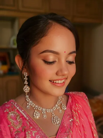 A close-up of Dhvani's soft, natural makeup. The focus is on clean skin and subtly defined eyes.