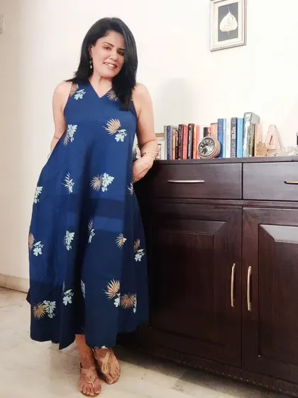 The full view of the tiered, sleeveless dress. This silhouette is flattering and comfortable, perfect for a warm summer evening.