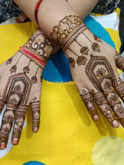 An elegant design with hanging jhumkis (earrings) and lotus motifs. This is a great choice for someone who wants a traditional but not-so-heavy design.