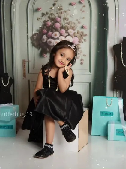A sweet and sassy pose from a little girl enjoying her high-fashion themed photoshoot.