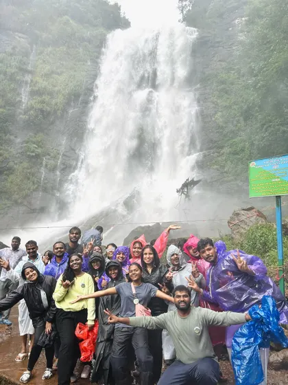 Pure joy and energy from our group in front of a massive waterfall.
