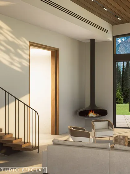 A suspended fireplace creates a cozy focal point in the corner of the living room, perfect for chilly mountain evenings. The large windows frame the stunning natural scenery outside.