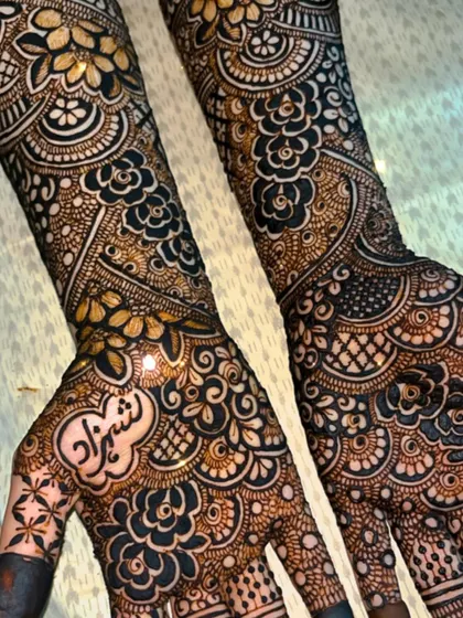 A detailed close-up of the palm work in a bridal design. The shading and fine lines create depth and dimension.