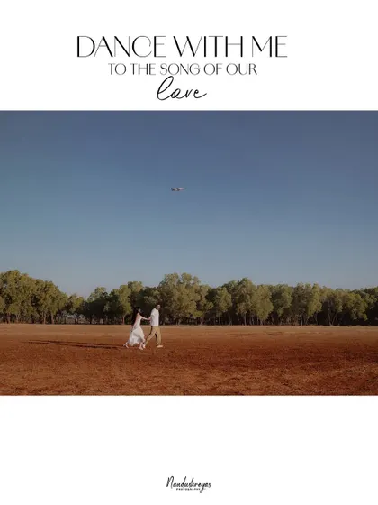 A wide shot of a couple dancing in a vast, open field under a clear blue sky, capturing a feeling of boundless joy and freedom.