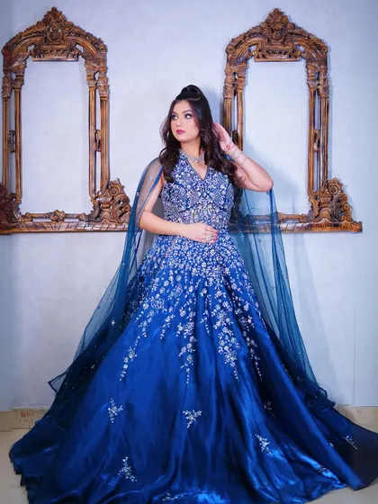 Another full-length shot of the blue ball gown, showing its grand silhouette.