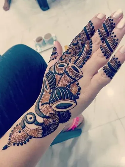 A unique and modern design featuring musical drums (tabla) as part of a flowing Arabic-style pattern.