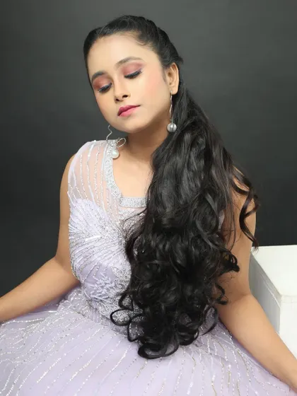 This close-up shows the detailed silver beadwork on the gown's bodice and the simple pearl drop earrings I pair with it.