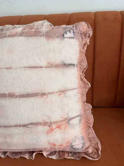 A closer look at the details on this naturally dyed cushion cover. The subtle variations in color and the ruffled edges are what make handmade items so special.