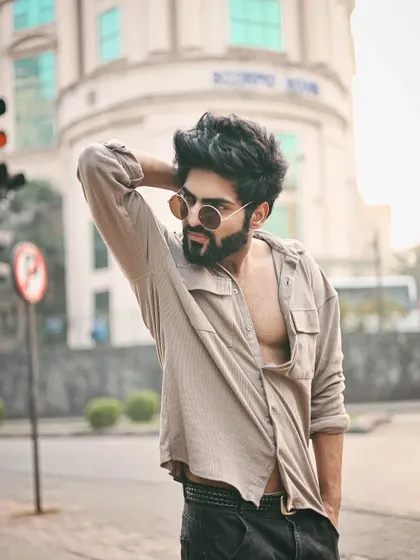 A strong pose that showcases the model's physique and the shirt's fit.