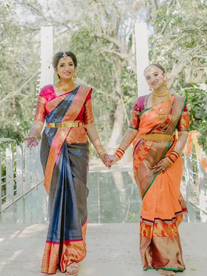A heartwarming photo of the bride and her mother, both dressed in beautiful Kanjeevaram sarees and custom Kalasthree blouses.