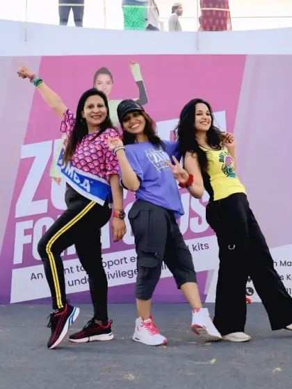 Posing with my fellow instructors on the 'Zumba for a Cause' stage. We work together to lead the crowd and ensure everyone has a fantastic, memorable time.