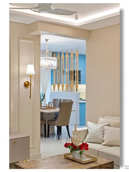 A detail shot showing the connection between the living and dining areas. The composition highlights the use of a decorative wooden partition to create a sense of separation while maintaining an open feel.