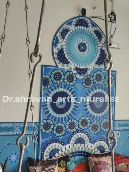A Moroccan-style mural created using a monochrome theme of blue. The intricate patterns and mandalas on the wall create a soothing and royal touch, perfectly complementing the swing.