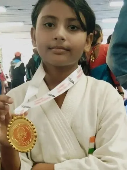 Priya Das with her gold medal from the South District championship. She is a powerful fighter.